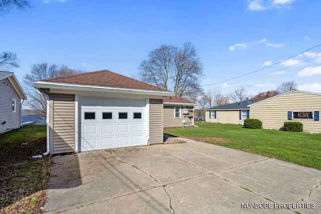 detached garage featuring driveway