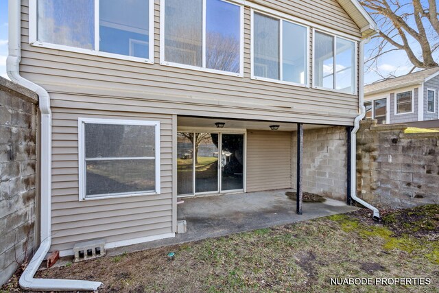 back of property featuring fence and a patio