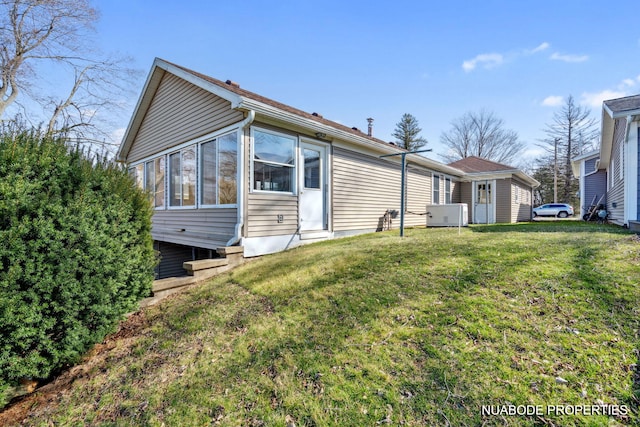 back of property with a lawn
