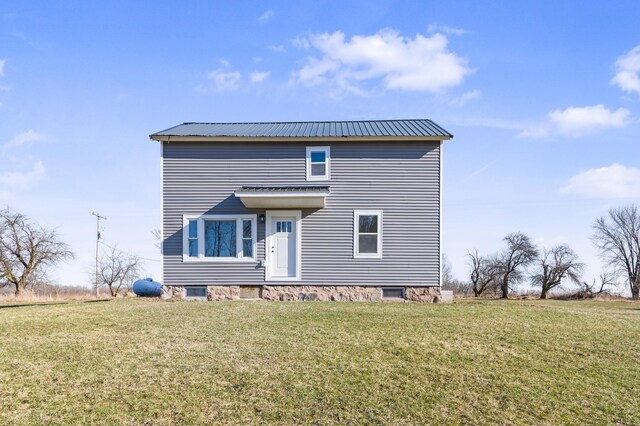 10282 7 Mile Rd, Evart, MI 49631 - rear view of house featuring metal roof and a yard