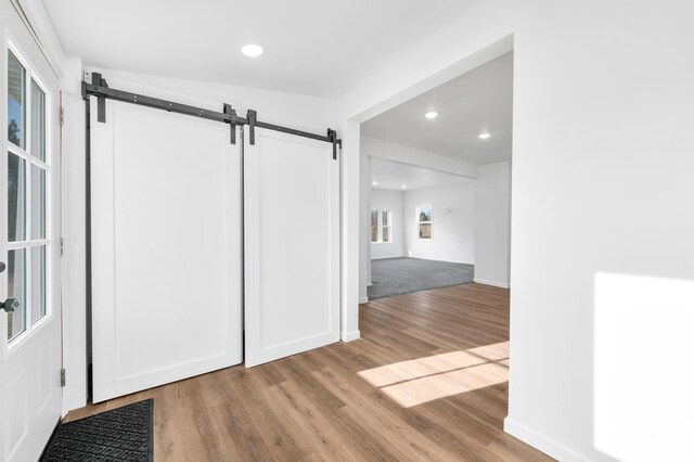 10282 7 Mile Rd, Evart, MI 49631 - interior space with a barn door, wood finished floors, and recessed lighting