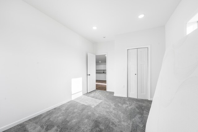 10282 7 Mile Rd, Evart, MI 49631 - unfurnished bedroom with baseboards, recessed lighting, a closet, and carpet