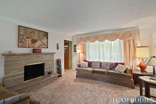 carpeted living area with a stone fireplace