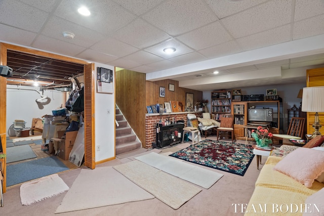 carpeted living room with wood walls and recessed lighting