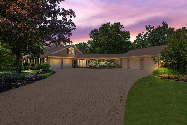 6130 Eidson Rd, Saint Joseph, MI 49085 - view of front of property featuring a garage and decorative driveway