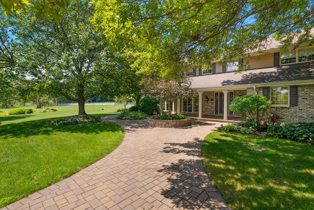 6130 Eidson Rd, Saint Joseph, MI 49085 - view of front facade featuring a front lawn and brick siding
