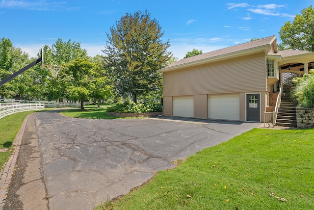 6130 Eidson Rd, Saint Joseph, MI 49085 - view of home's exterior with stairs, a garage, and driveway