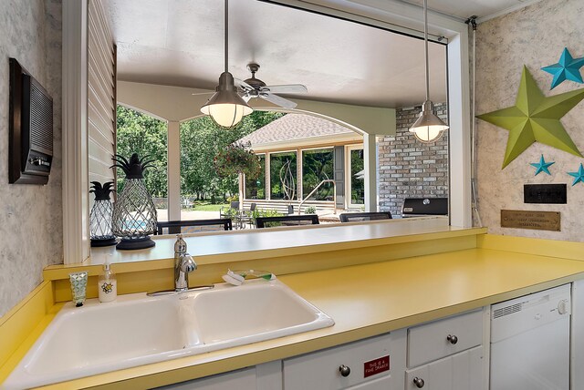 6130 Eidson Rd, Saint Joseph, MI 49085 - kitchen featuring a sink, dishwasher, healthy amount of natural light, hanging light fixtures, and wallpapered walls