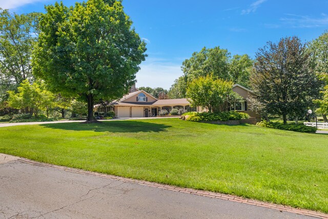 6130 Eidson Rd, Saint Joseph, MI 49085 - view of front of home with a garage, a front yard, and driveway