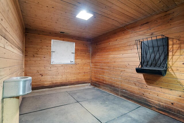 6130 Eidson Rd, Saint Joseph, MI 49085 - unfurnished room featuring concrete floors, wooden walls, and wooden ceiling