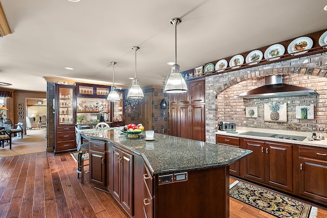 6130 Eidson Rd, Saint Joseph, MI 49085 - kitchen featuring wall chimney range hood, black electric cooktop, dark wood-style floors, and a kitchen island