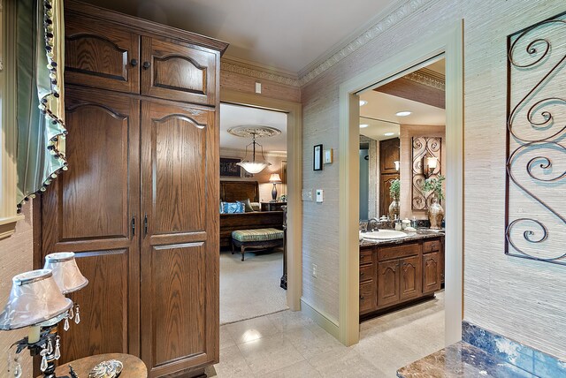 6130 Eidson Rd, Saint Joseph, MI 49085 - bathroom with vanity, ensuite bathroom, crown molding, baseboards, and wallpapered walls
