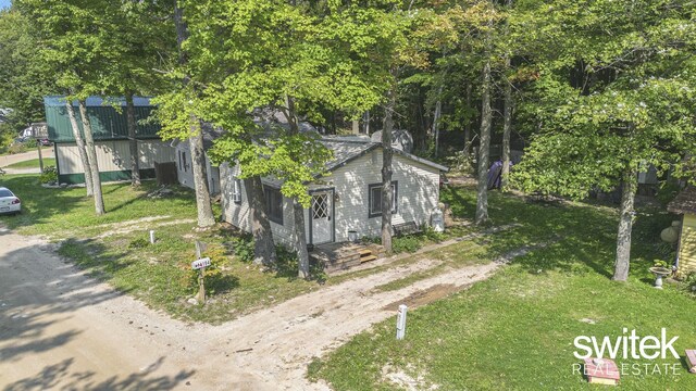 14194 Hicks Lake Rd, Evart, MI 49631 - exterior space with dirt driveway and a lawn