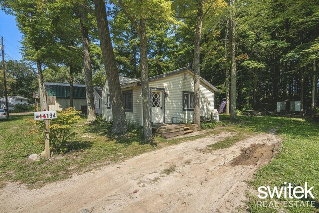 14194 Hicks Lake Rd, Evart, MI 49631 - view of front of property with dirt driveway