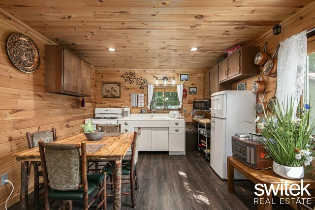 14194 Hicks Lake Rd, Evart, MI 49631 - kitchen with dark wood-style flooring, wooden walls, white appliances, wood ceiling, and light countertops