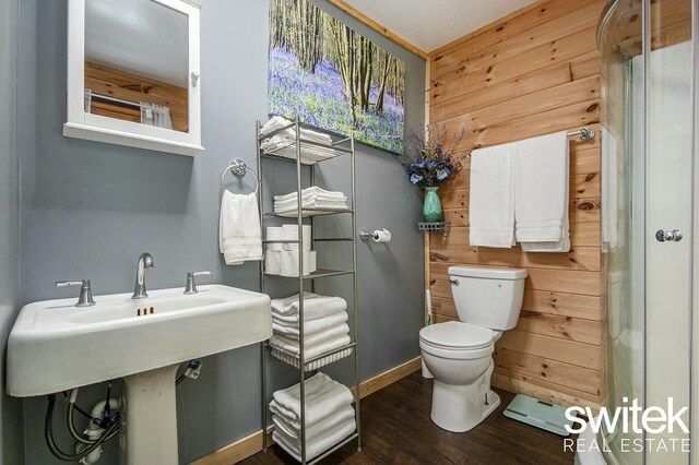 14194 Hicks Lake Rd, Evart, MI 49631 - bathroom featuring wooden walls, wood finished floors, and toilet