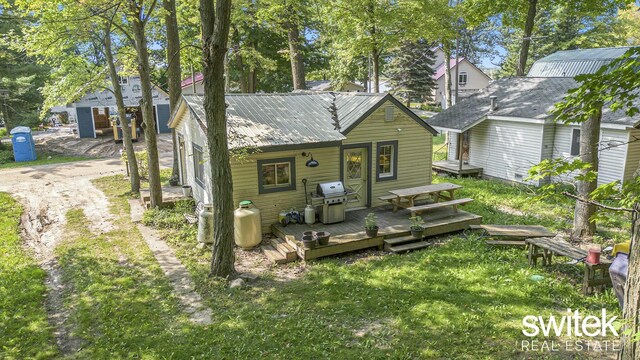 14194 Hicks Lake Rd, Evart, MI 49631 - back of house featuring a wooden deck and metal roof