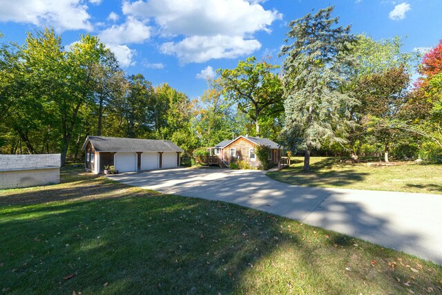 306 Eubank St, Novi, MI 48377 - view of front facade with an outbuilding, a detached garage, and a front lawn
