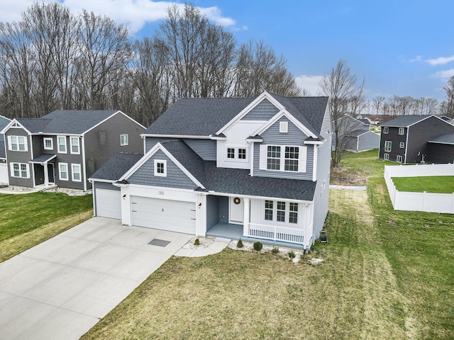 7434 Bramling Dr SE, Caledonia, MI 49316 - traditional home with a shingled roof, an attached garage, a front lawn, a residential view, and driveway