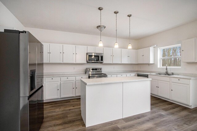 7434 Bramling Dr SE, Caledonia, MI 49316 - kitchen featuring a sink, white cabinets, dark wood-type flooring, and stainless steel appliances