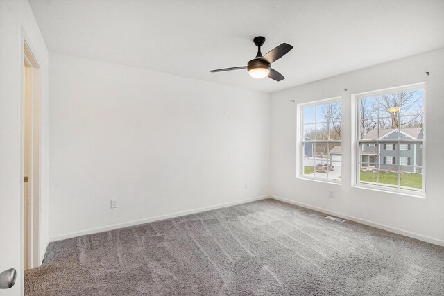 7434 Bramling Dr SE, Caledonia, MI 49316 - carpeted empty room featuring visible vents, baseboards, and a ceiling fan