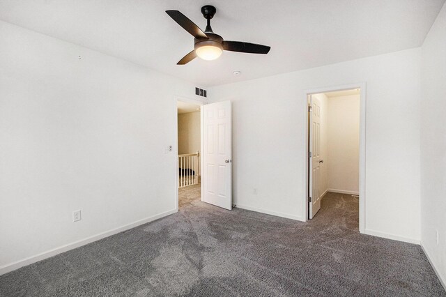 7434 Bramling Dr SE, Caledonia, MI 49316 - unfurnished bedroom featuring carpet, a ceiling fan, visible vents, a walk in closet, and baseboards