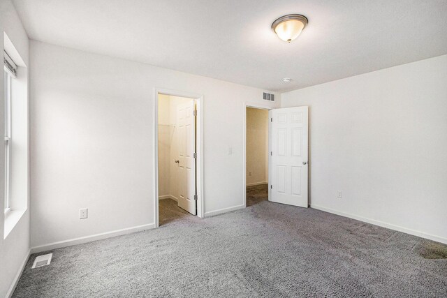 7434 Bramling Dr SE, Caledonia, MI 49316 - unfurnished bedroom with carpet, visible vents, and baseboards