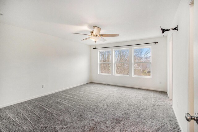 7434 Bramling Dr SE, Caledonia, MI 49316 - empty room featuring carpet flooring, baseboards, and a ceiling fan