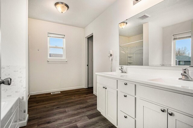 7434 Bramling Dr SE, Caledonia, MI 49316 - full bath featuring a sink, baseboards, a shower, and wood finished floors