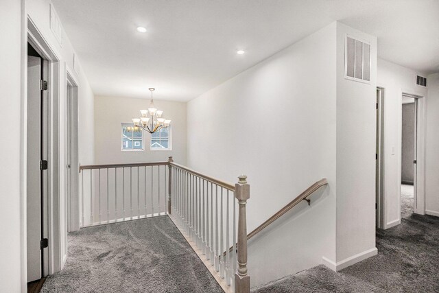 7434 Bramling Dr SE, Caledonia, MI 49316 - corridor with a chandelier, an upstairs landing, visible vents, and carpet floors