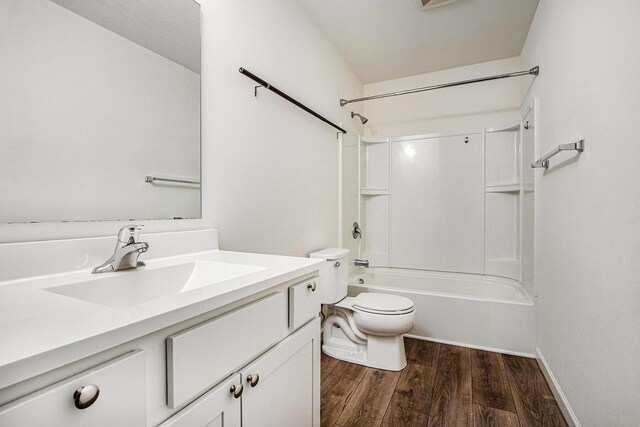 7434 Bramling Dr SE, Caledonia, MI 49316 - bathroom featuring toilet, wood finished floors, vanity, and shower / washtub combination