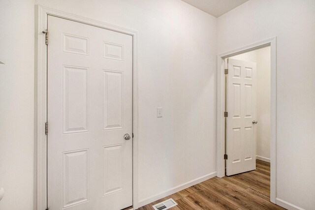 7434 Bramling Dr SE, Caledonia, MI 49316 - corridor with wood finished floors, baseboards, and visible vents