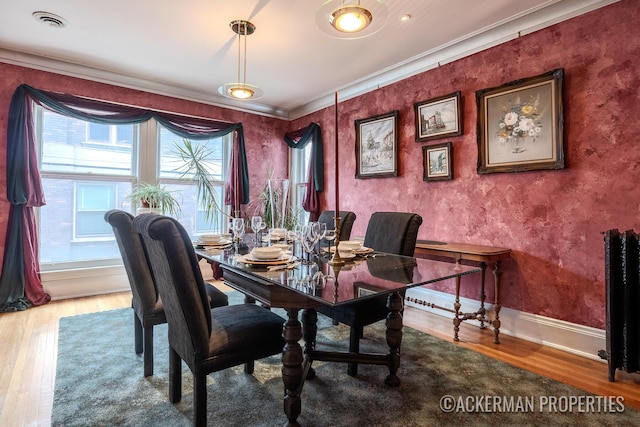 234 Madison Ave SE, Grand Rapids, MI 49503 - dining area featuring wood finished floors, baseboards, ornamental molding, and visible vents
