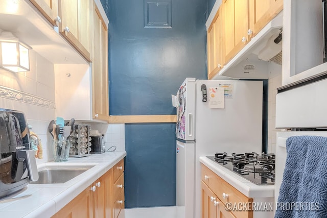 234 Madison Ave SE, Grand Rapids, MI 49503 - kitchen featuring tasteful backsplash, tile countertops, black gas stovetop, and light brown cabinetry