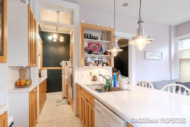 234 Madison Ave SE, Grand Rapids, MI 49503 - kitchen with tile countertops, open shelves, dishwasher, a sink, and backsplash