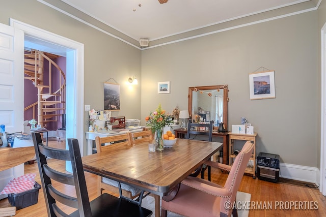 234 Madison Ave SE, Grand Rapids, MI 49503 - dining space with crown molding, baseboards, light wood finished floors, and stairs