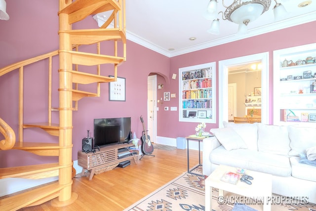 234 Madison Ave SE, Grand Rapids, MI 49503 - living room featuring crown molding, baseboards, arched walkways, and wood finished floors