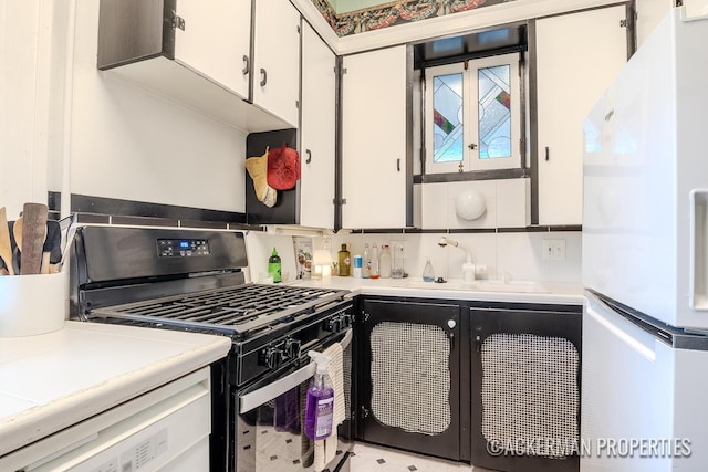 234 Madison Ave SE, Grand Rapids, MI 49503 - kitchen featuring white appliances, white cabinetry, a sink, light countertops, and decorative backsplash