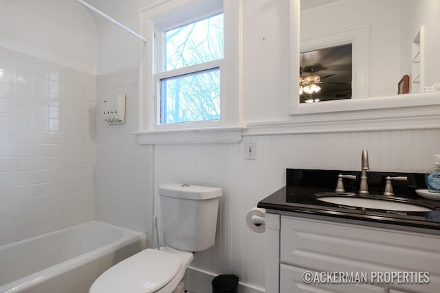 234 Madison Ave SE, Grand Rapids, MI 49503 - bathroom featuring toilet, vanity, bathtub / shower combination, and a wainscoted wall