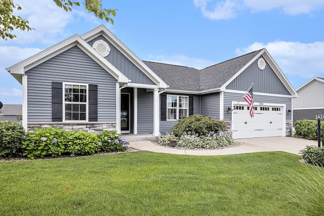 view of front of property with a front lawn, driveway, an attached garage, and stone siding