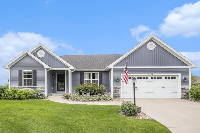 single story home featuring stone siding, an attached garage, a front yard, and driveway