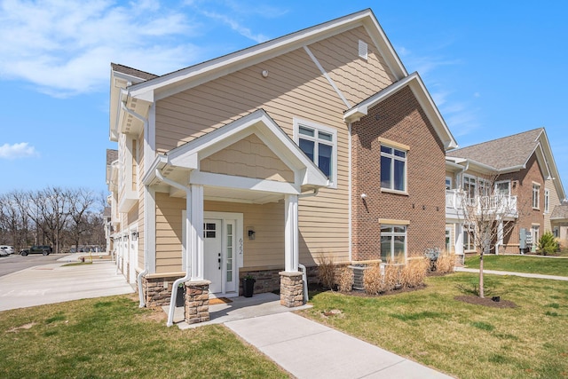 view of front of house featuring a front yard and stone siding