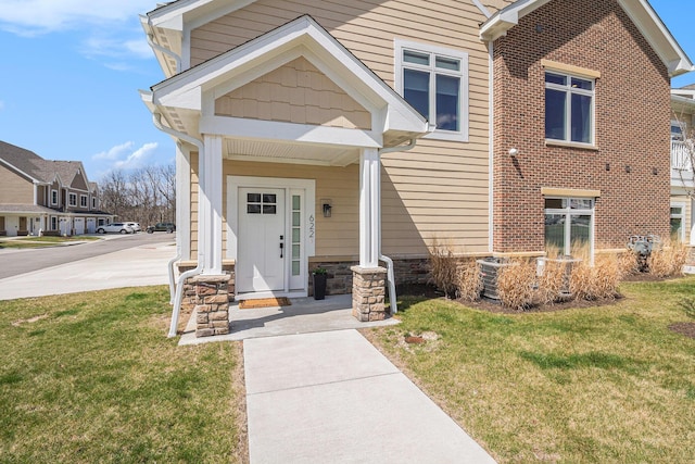 view of front of property featuring a front yard and stone siding
