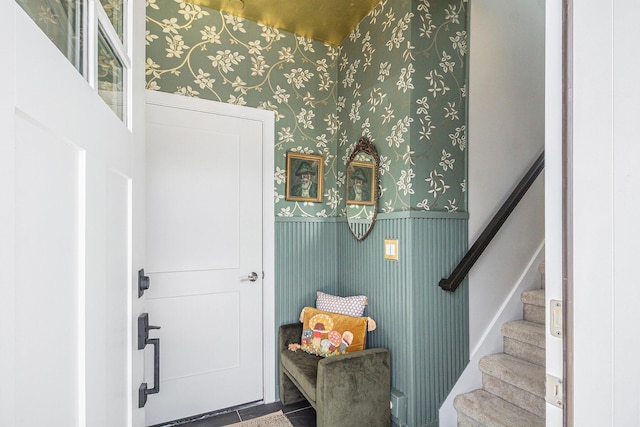 entrance foyer with stairway and wallpapered walls