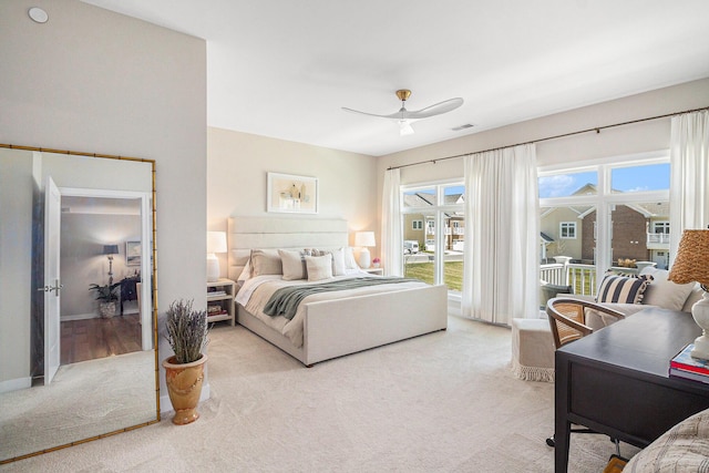 bedroom with visible vents, access to outside, light colored carpet, and multiple windows