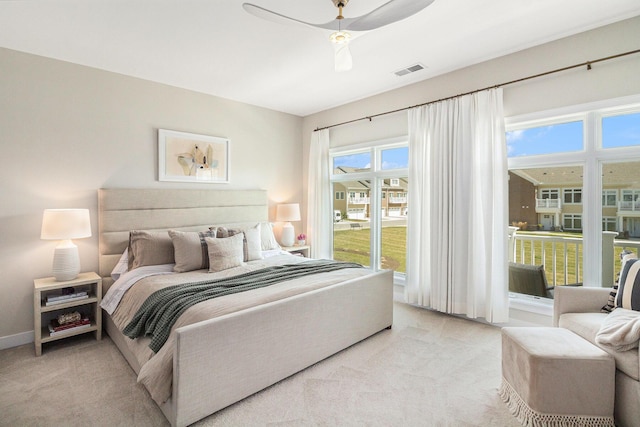 bedroom with access to outside, visible vents, a ceiling fan, and light carpet