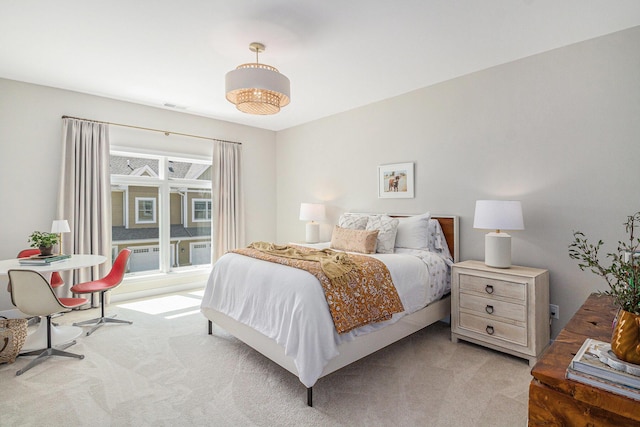 bedroom featuring visible vents and light colored carpet