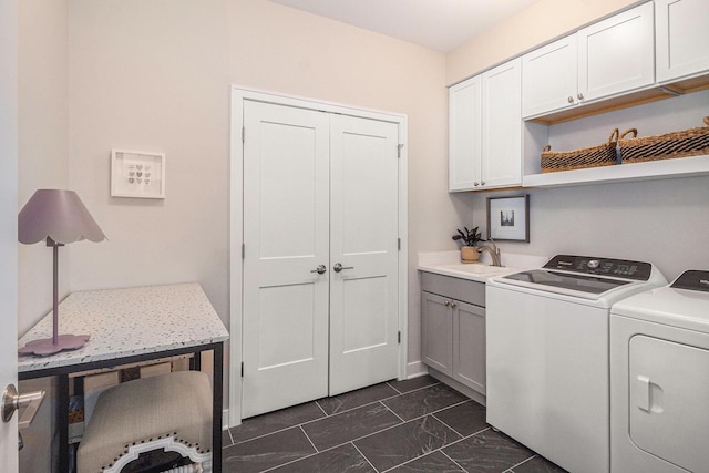 clothes washing area featuring washing machine and dryer, marble finish floor, a sink, and cabinet space