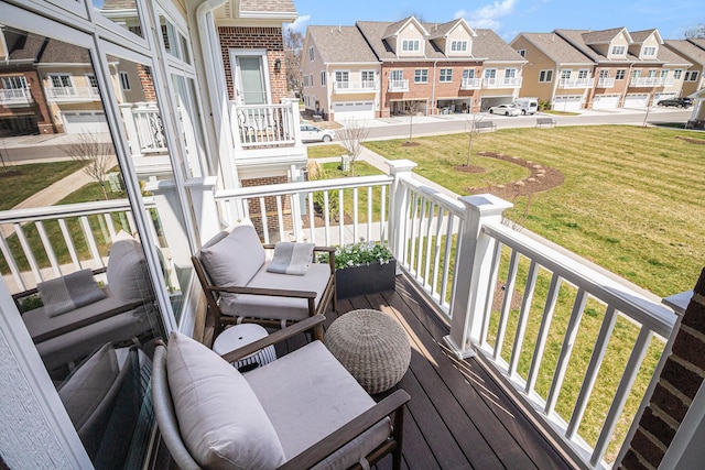 wooden terrace featuring a residential view and a yard