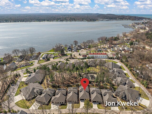 drone / aerial view featuring a residential view and a water view